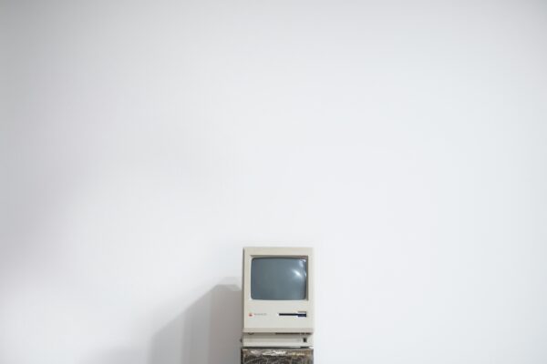 Old computer against a white wall